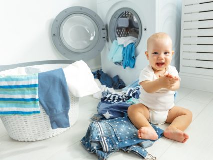bebé no meio de roupa lavada