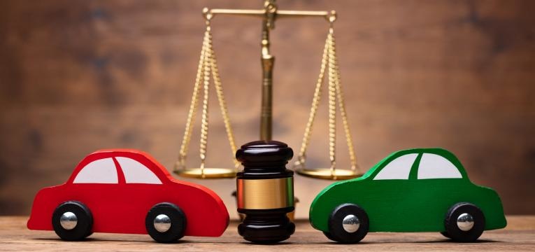 Two Red And Green Car In Front Of Justice Scale