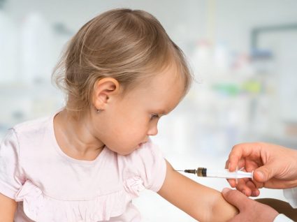 Menina a tomar vacina